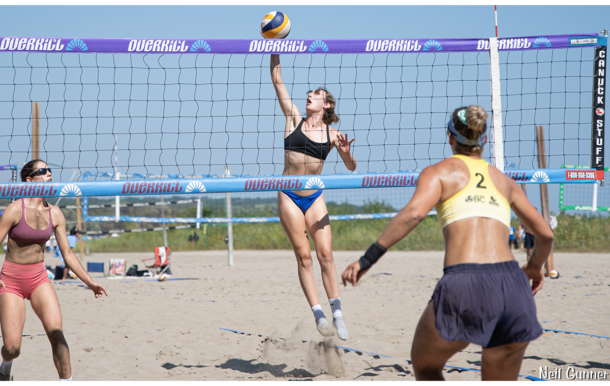 Beach volleyball player about to send the ball over the net