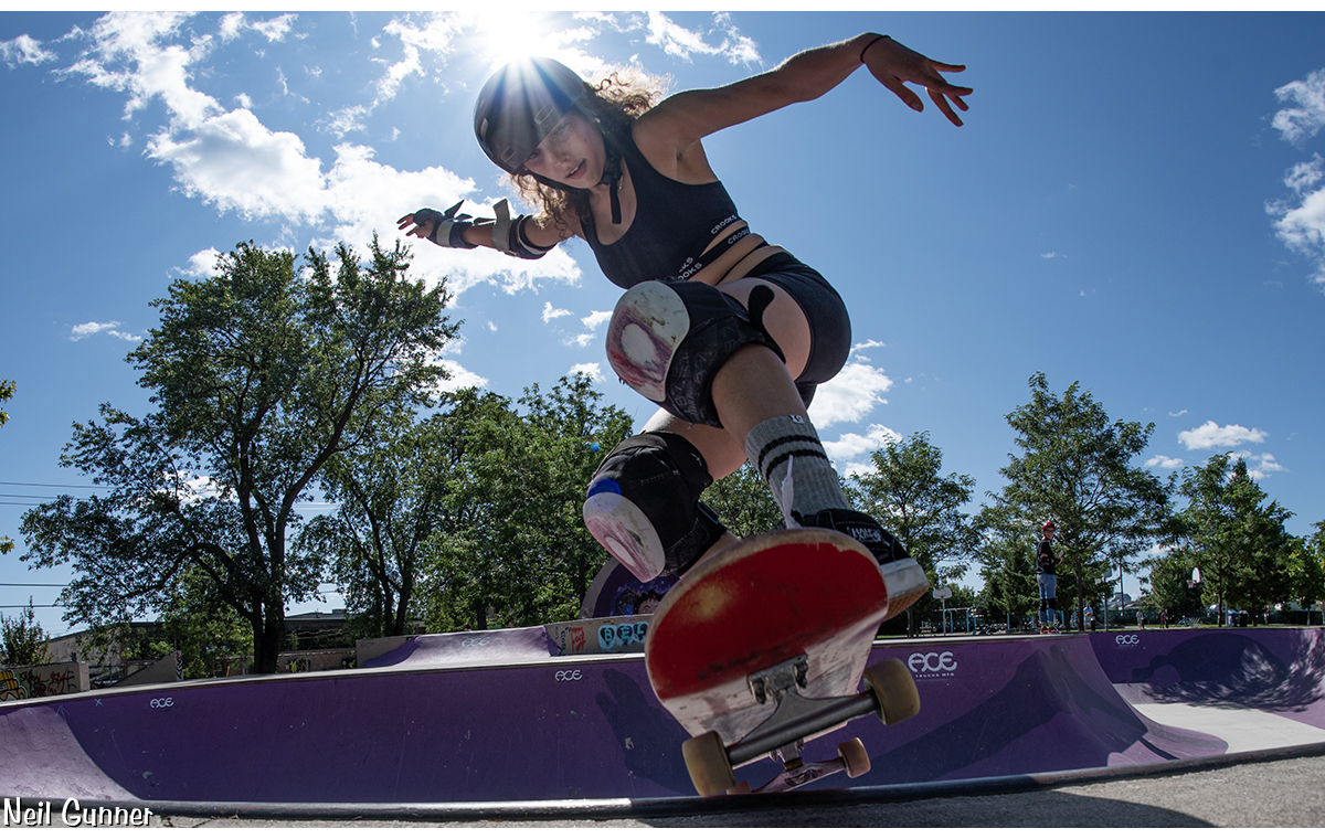 Sharlene crests the coping on a sunny day