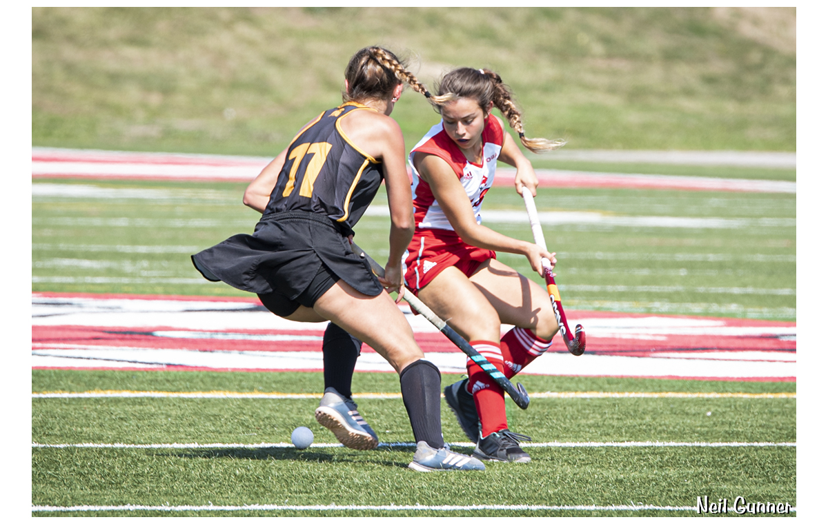 Field hockey players fight for the ball