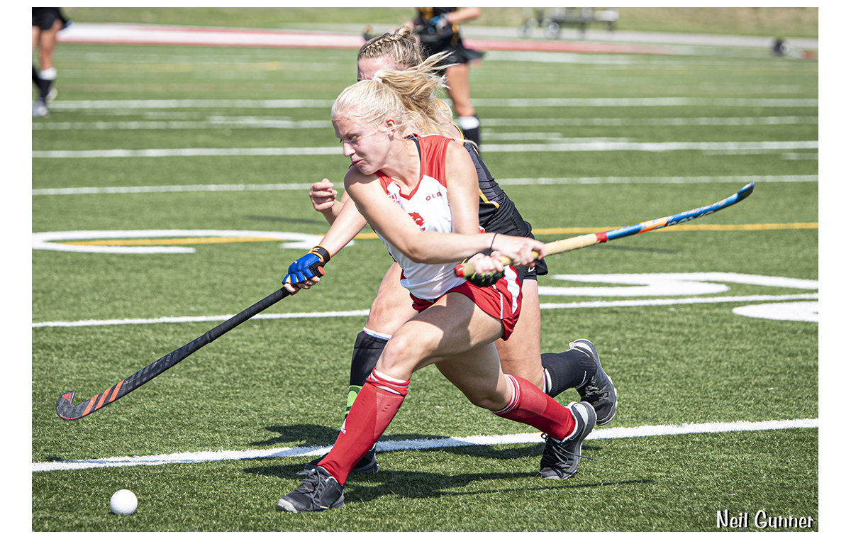 Field hockey players fight for the ball