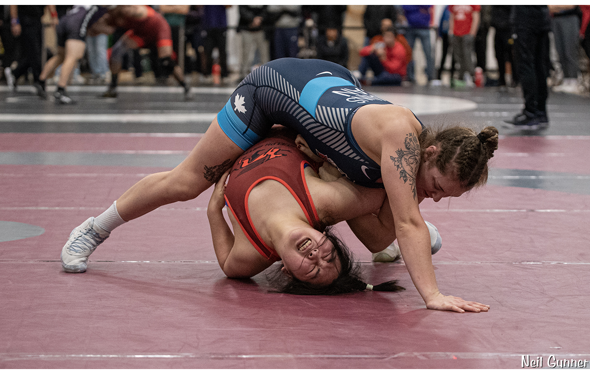 Wrestler tries to prevent the pin